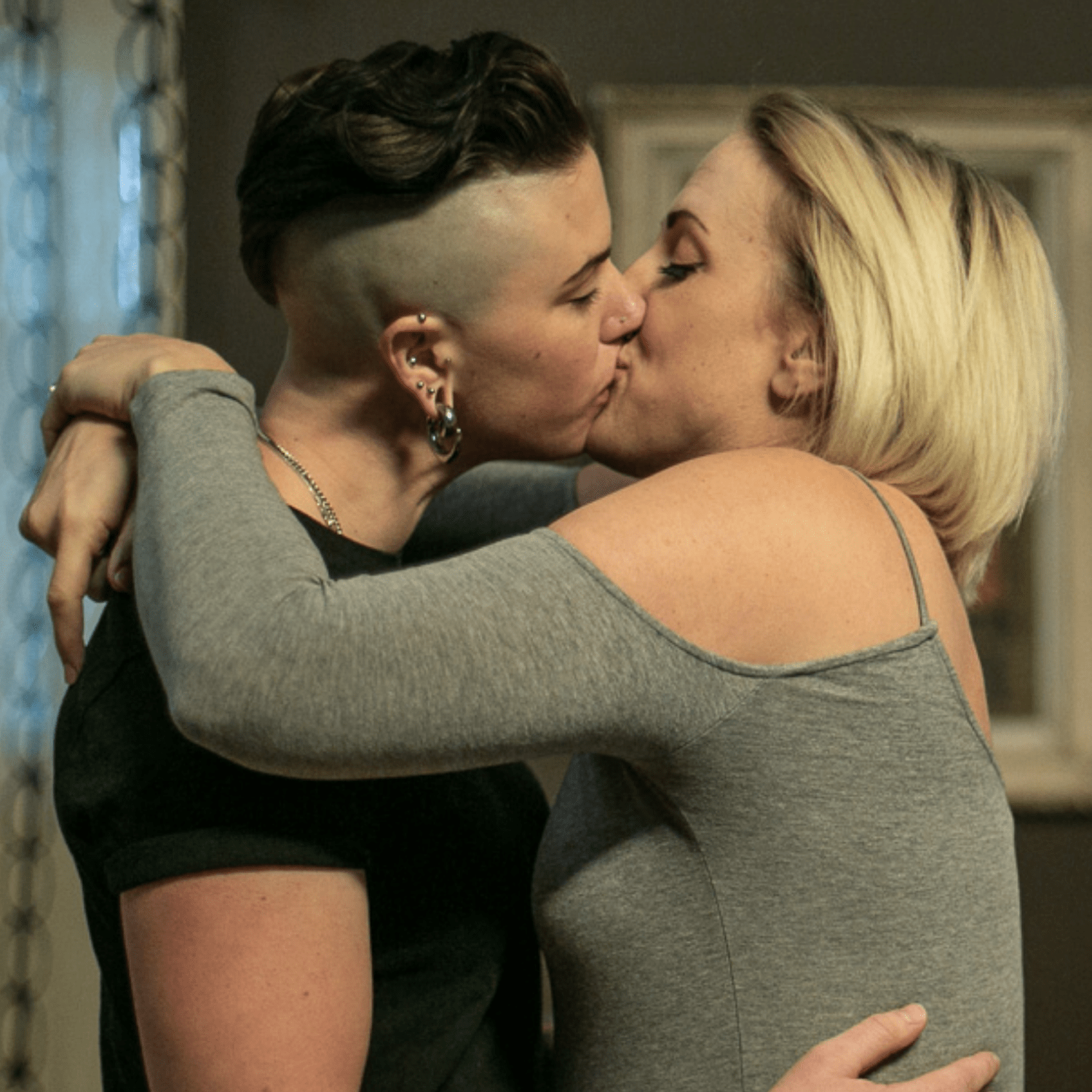 Two women kissing passionately